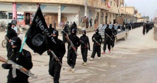 FILE - This undated file image posted on a militant website on Jan. 14, 2014, shows fighters from the Islamic State group marching in Raqqa, Syria. T (AP Photo/Militant Website, File)