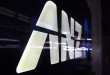 A man is reflected in a logo for the Australia and New Zealand Banking Group Ltd (ANZ) as he walks past a branch located in a Sydney suburb February 17, 2015. ANZ on Tuesday posted a 3.5 percent rise in first-quarter cash profit, warning that 2015 was shaping up to be a "slightly tougher, more volatile" environment. ANZ reported cash profit of A$1.79 billion ($1.39 billion) for the three months to Dec. 31, compared with A$1.73 billion a year ago, led by a strong domestic performance, while lower trading income and higher expenses hurt revenue growth.  REUTERS/David Gray     (AUSTRALIA - Tags: BUSINESS LOGO) - RTR4PV6V