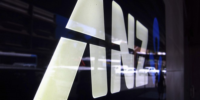 A man is reflected in a logo for the Australia and New Zealand Banking Group Ltd (ANZ) as he walks past a branch located in a Sydney suburb February 17, 2015. ANZ on Tuesday posted a 3.5 percent rise in first-quarter cash profit, warning that 2015 was shaping up to be a "slightly tougher, more volatile" environment. ANZ reported cash profit of A$1.79 billion ($1.39 billion) for the three months to Dec. 31, compared with A$1.73 billion a year ago, led by a strong domestic performance, while lower trading income and higher expenses hurt revenue growth.  REUTERS/David Gray     (AUSTRALIA - Tags: BUSINESS LOGO) - RTR4PV6V